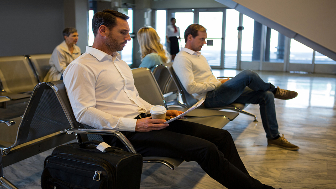 Passenger Sitting on Airport Waiting Area Chairs