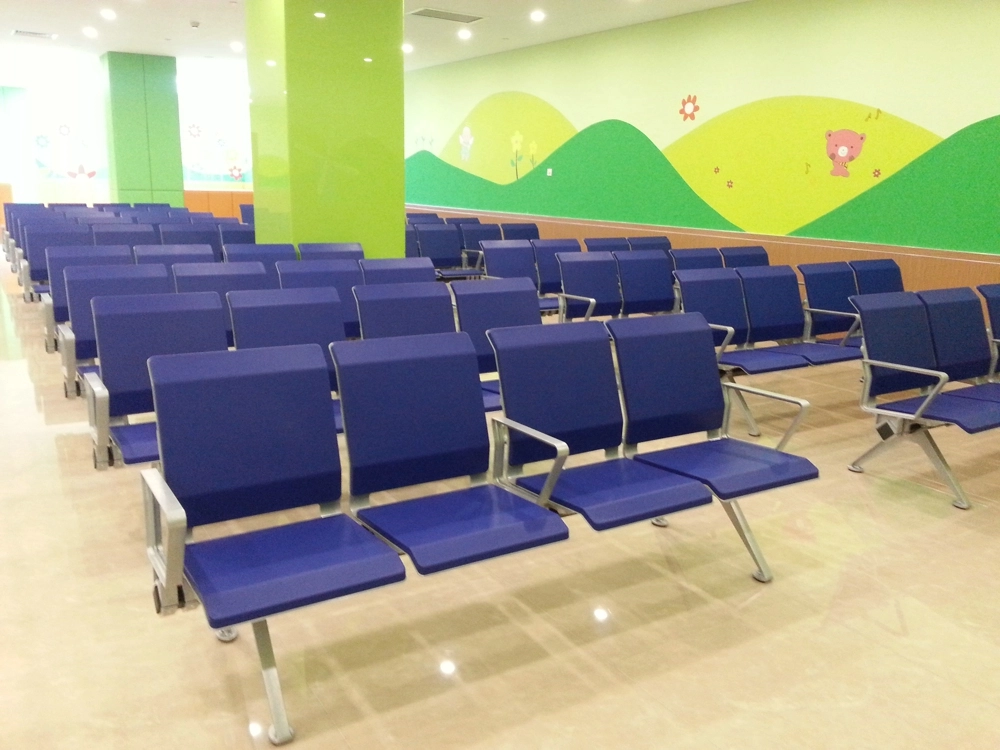 hospital-waiting-chairs Rows of blue waiting chairs in a brightly colored waiting room with a child-friendly mural.