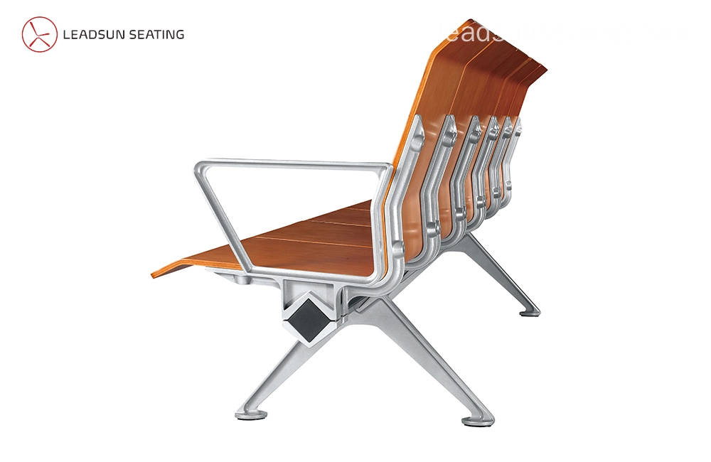 Ergonomic-Design-chair Here's a descriptive alt text for the image:
"Side view of a modern, multi-seat bench with a light brown wooden seat and silver aluminum frame and legs."