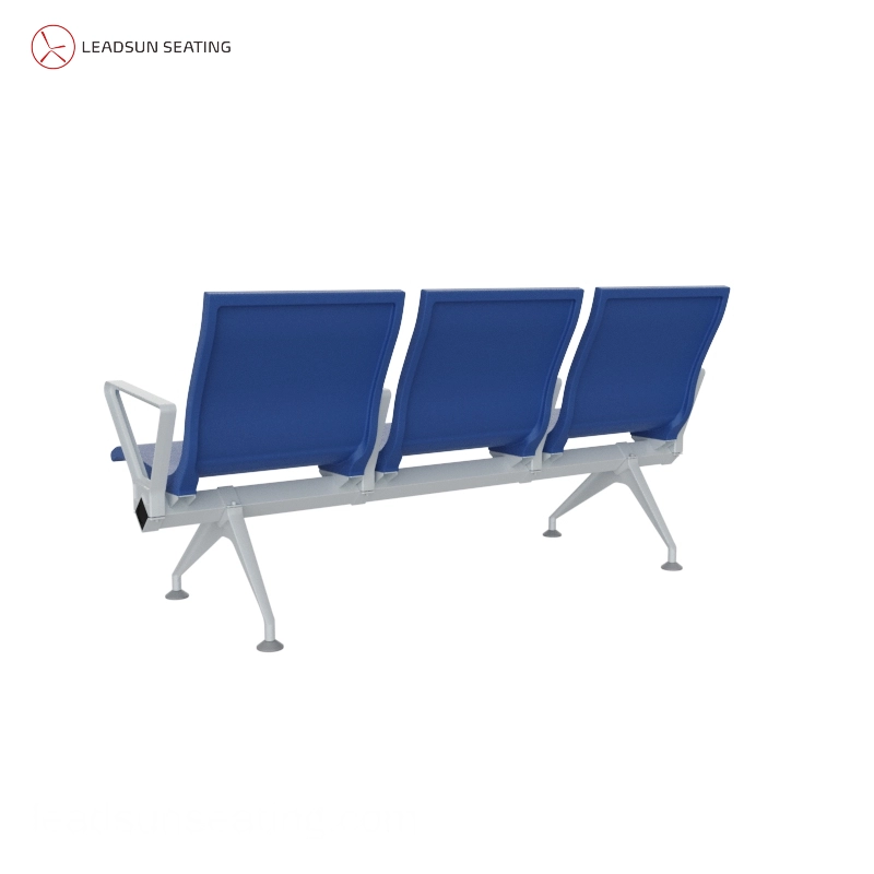 Passengers seated on blue aluminum-framed airport chairs with luggage