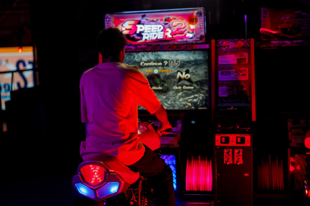 Person playing an arcade game machine.