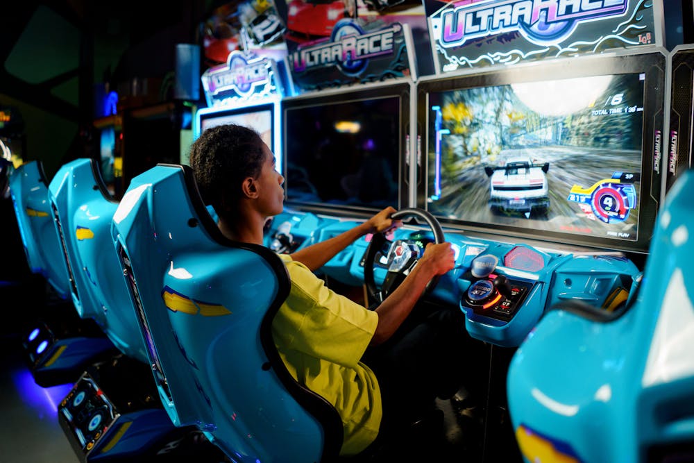 Teenager playing an Ultra Race arcade game.