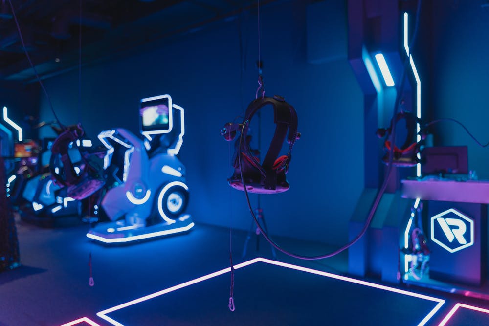 VR 360 simulator gaming station with glowing neon lights.