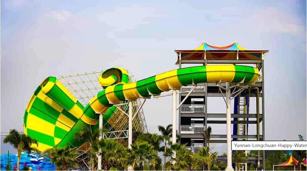 Green and yellow water slide at a water park. - WM International