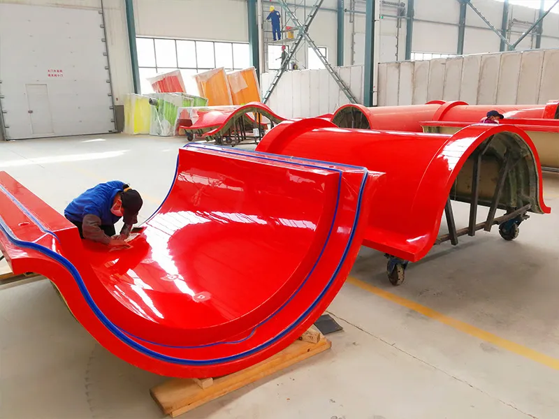 Fiberglass slide sections and molds in the WM International production workshop