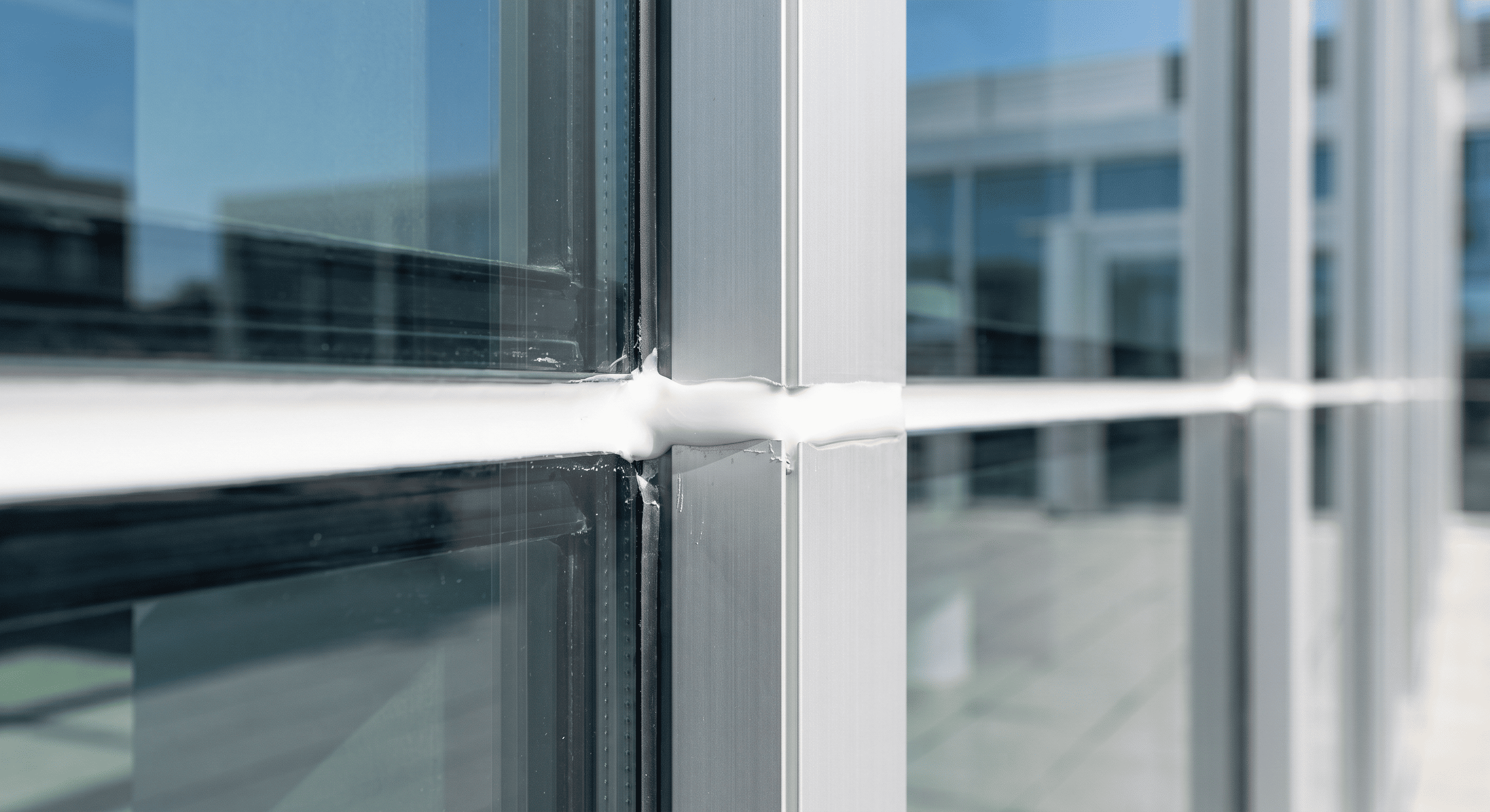 white MS polymer sealant joint on a modern glass and aluminum facade (1) white MS polymer sealant joint on a modern glass and aluminum facade (1)