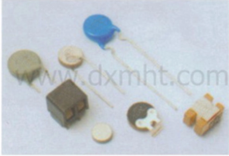 Assortment of PTC thermistors, including disk, chip, and cylindrical types.