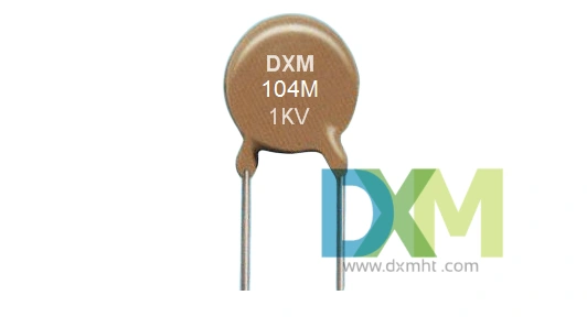 Close-up of a DXM 104M 1KV high voltage ceramic disc capacitor.  The brown 104 capacitor has axial leads.