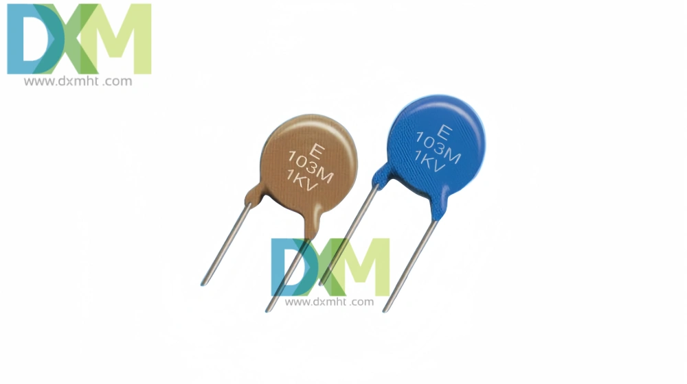 Two Capacitator components, one brown and one blue, on a white background. Both have "E 103M 1KV" printed on them.