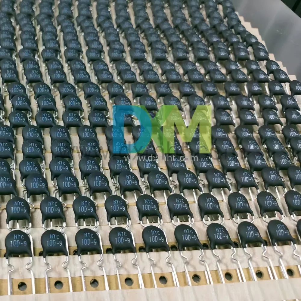 NTC 10D-9 Thermistor MF72 - DXM A close-up image of a large quantity of NTC 10D-9 Thermistor MF72 components, which are small, cylindrical Thermistor NTC 10D 9 for surge suppression - DXM