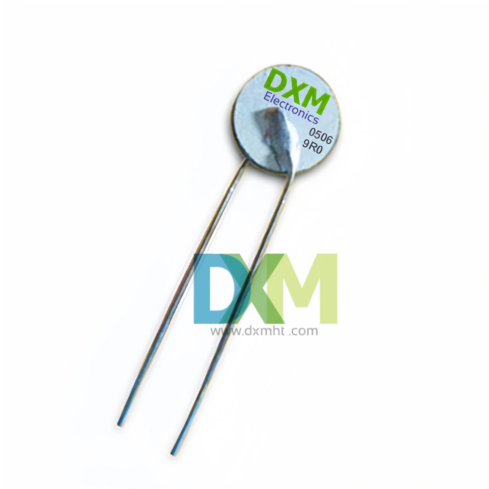 A silver PTC thermistor without coating with two leads and a round element ptc,marked with the company name "DXM Electronics" and a product code. The ptc element is used for telecom termination.