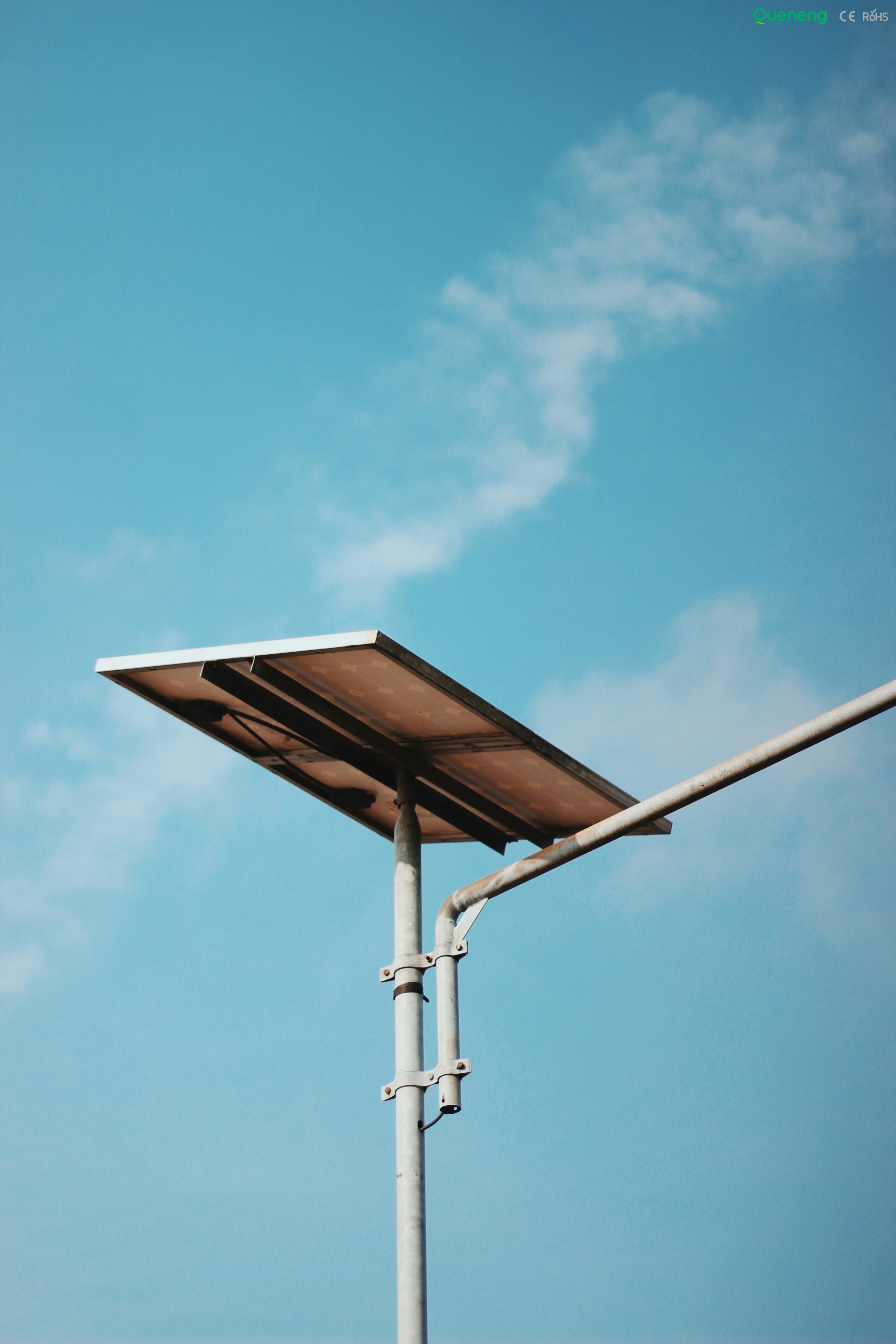 solar panel A single solar panel stands tall against a bright blue sky, symbolizing clean energy.