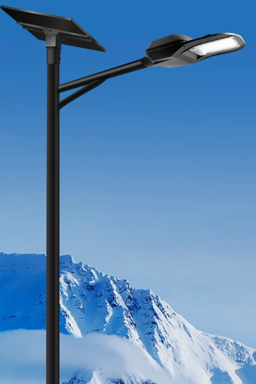 Solar-powered LED street light against a backdrop of snow-capped mountains under a bright blue sky.
