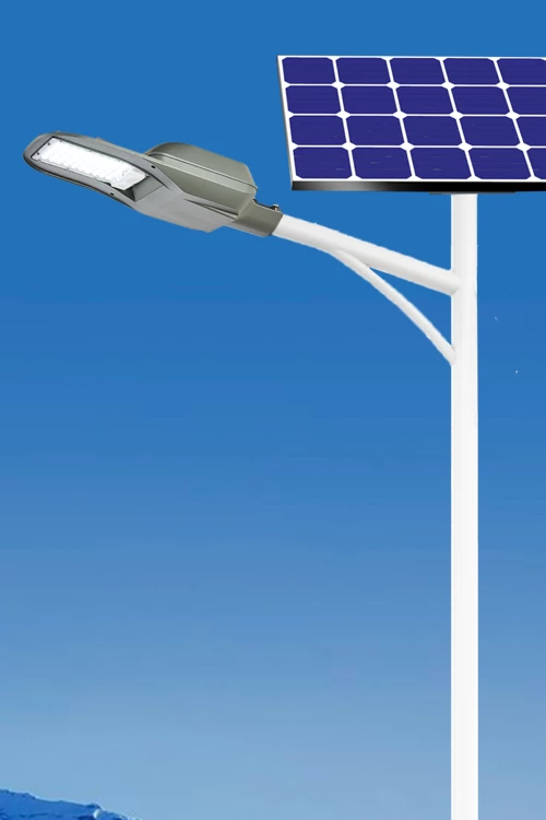 Solar-powered LED street light with a gray light fixture and a blue solar panel mounted on a white pole against a clear blue sky.