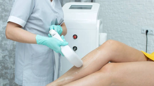 Laser machine for hair removal treatment on legs.