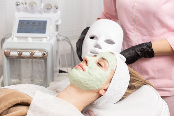 A woman receives a facial treatment with laser hair removal machines.