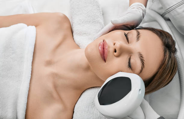 A woman uses a beauty face device effortlessly.