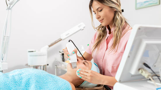 ND Yag laser for skin treatment: a dermatologist uses a laser on a patient's face.