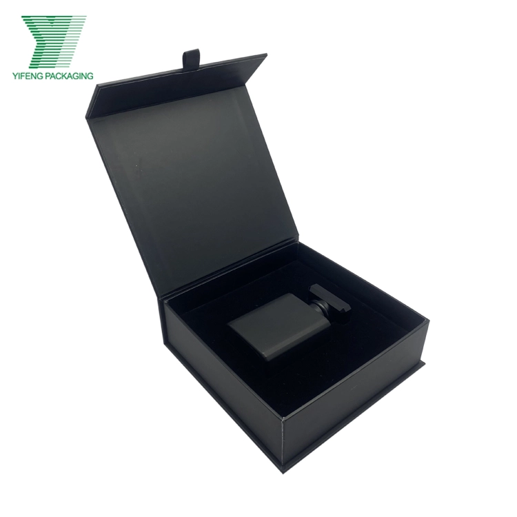 Open black magnetic gift box holding a matte black perfume bottle. - Yifeng Packaging