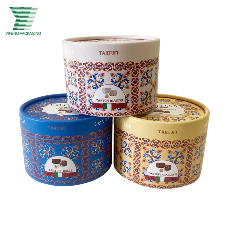 Three decorative round truffle tins in white, blue, and yellow patterns. - Yifeng Packaging
