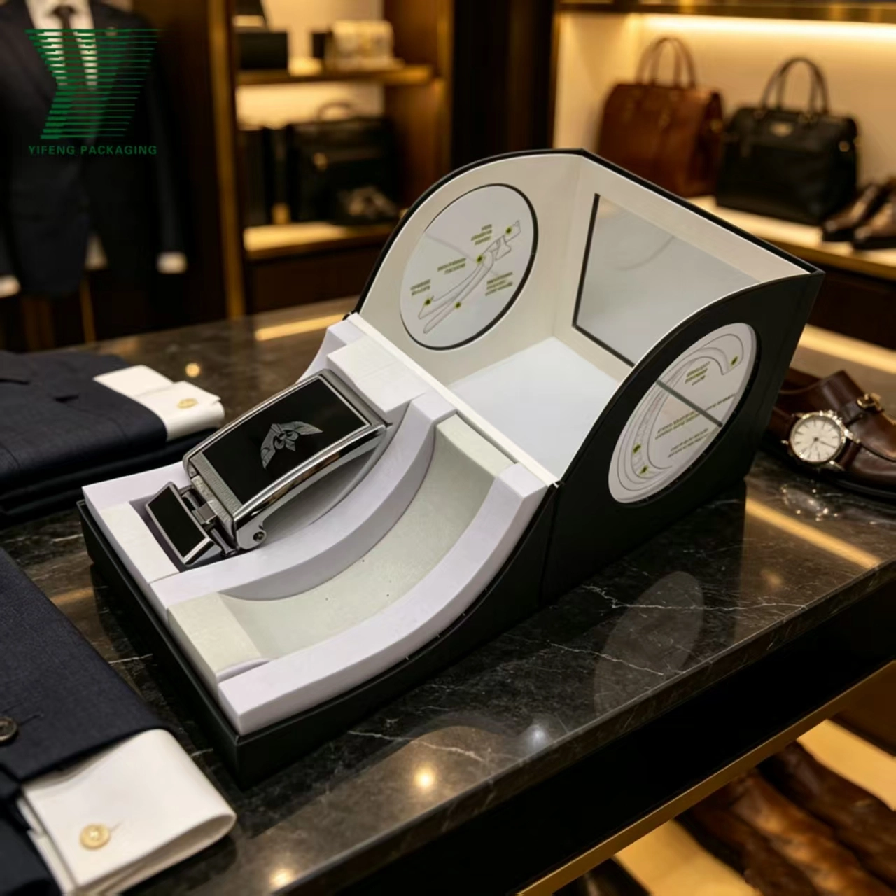 Luxury black and white belt display box with a silver buckle on a marble table. - Yifeng Packaging