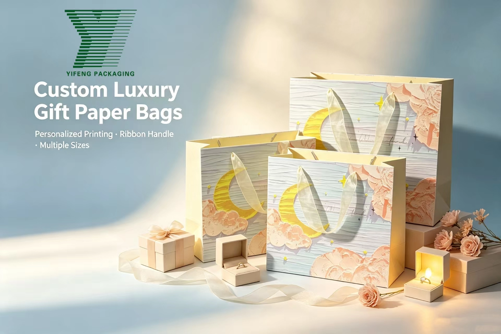 Custom luxury gift paper bags with ribbon handles and crescent moon designs. - Yifeng Packaging