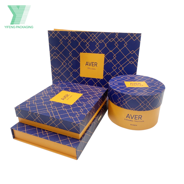 Blue and gold geometric patterned chocolate gift boxes in various shapes.