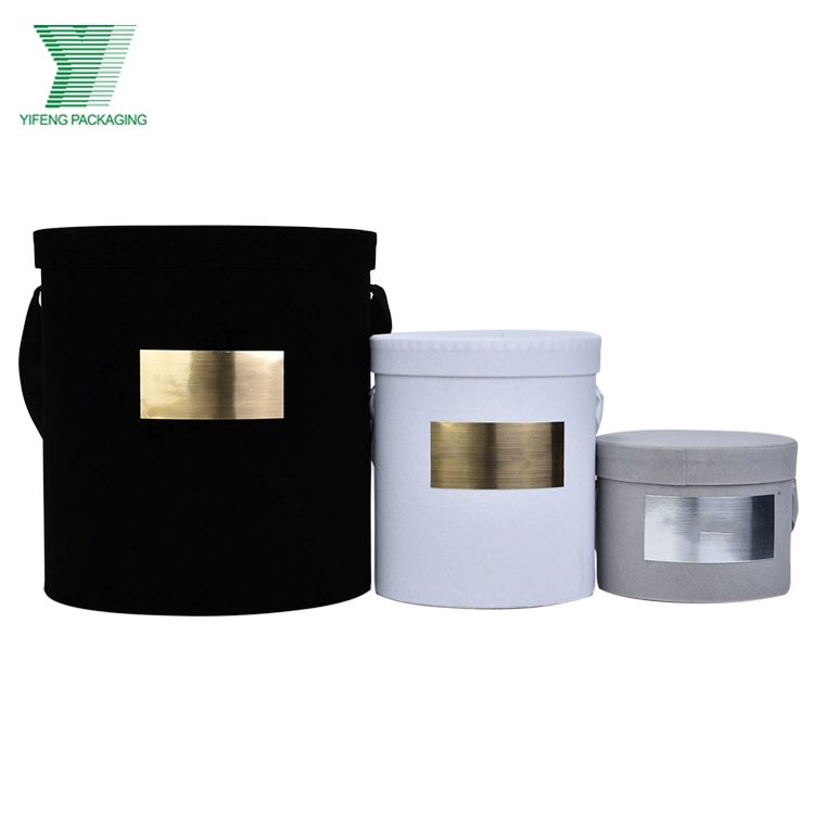 Three luxury velvet round flower boxes in black, white, and grey with gold tags. - Yifeng Packaging