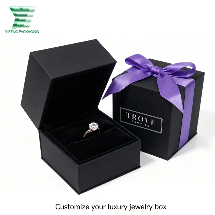 A diamond ring in a custom black luxury jewelry box with a purple ribbon. - Yifeng Packaging