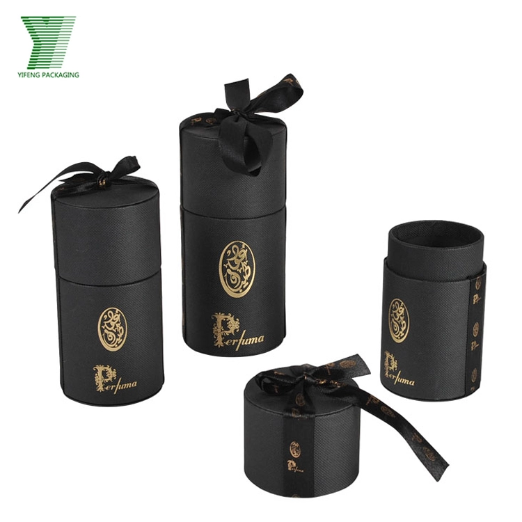 Black textured cylinder perfume boxes with gold logos and black ribbons. - Yifeng Packaging