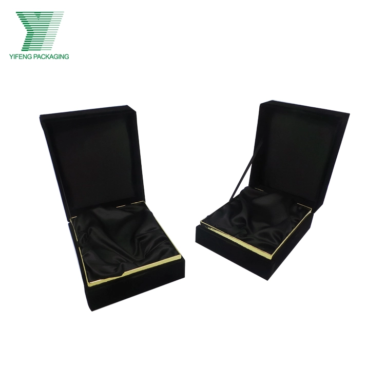 Two open black velvet gift boxes with gold trim and satin lining. - Yifeng Packaging