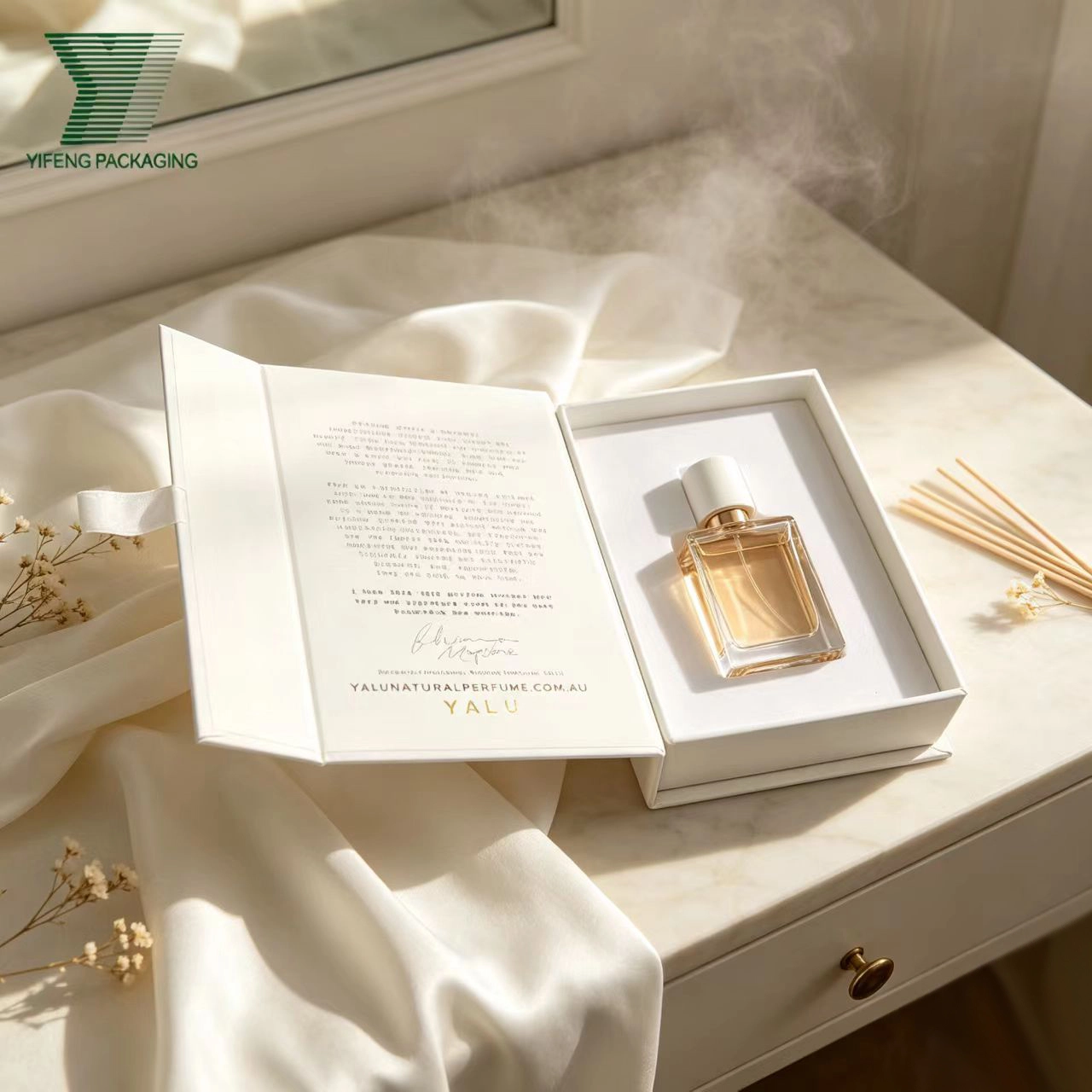 Luxury perfume bottle in an elegant white magnetic gift box on a marble table. - Yifeng Packaging