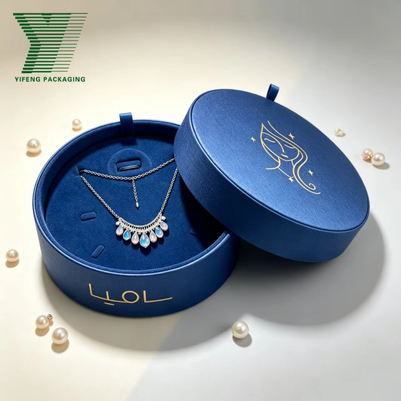 Elegant round blue jewelry box with a silver necklace and opal pendants. - Yifeng Packaging