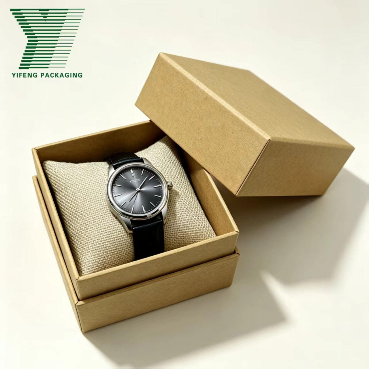 Silver watch with black strap in a kraft paper gift box on a burlap pillow. - Yifeng Packaging