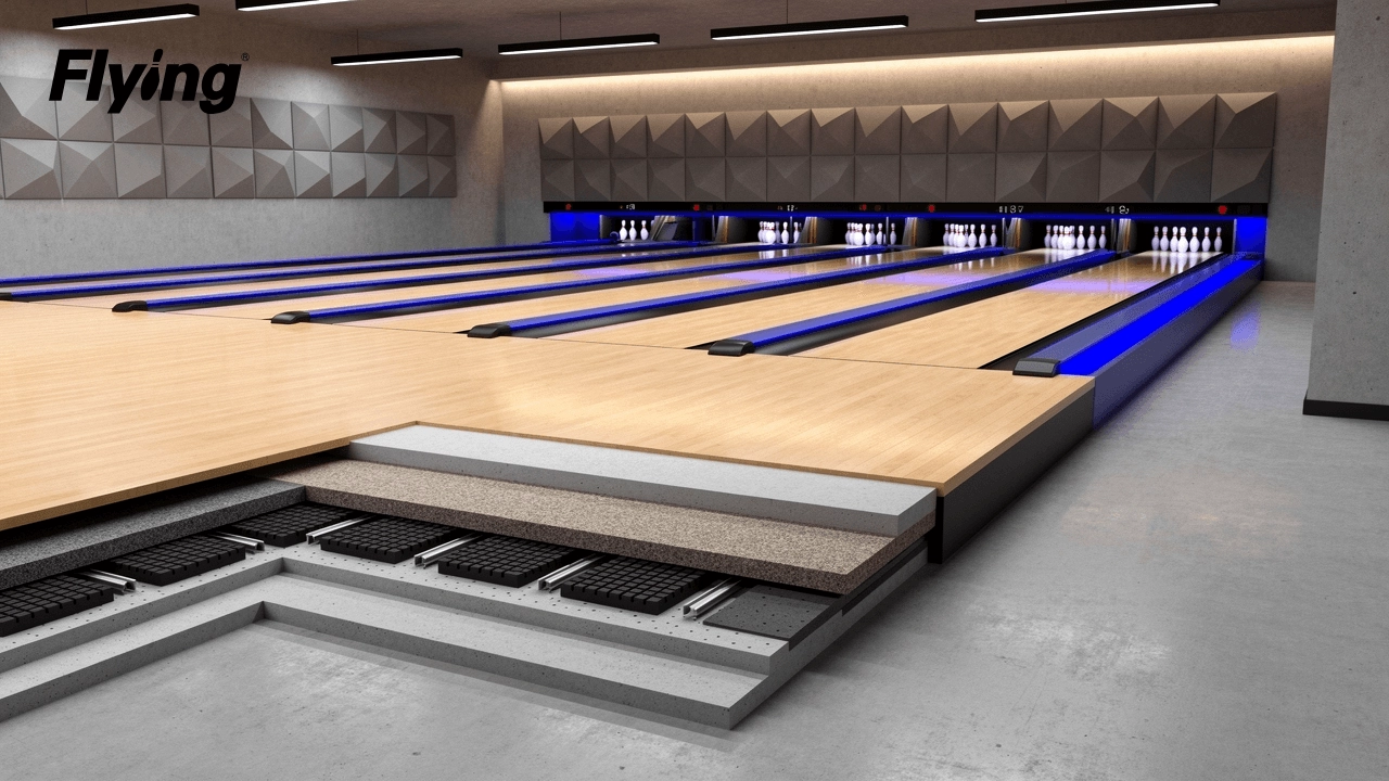 Commercial bowling lane installation featuring acoustic underlayment cutaway and structural vibration isolation details.